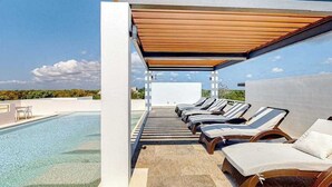 A rooftop pool area with lounge chairs and a clear view of the sky. - 1BR condo near Akumal beach, rooftop pool (Akumal)
