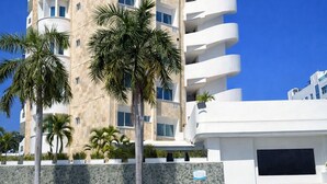 A modern hotel with a prominent 'Mar Abierto' sign, featuring a multi-story structure with balconies and a cylindrical tower. - Cartagena Beach Front
You will be Living the life on the beach (Cartagena)