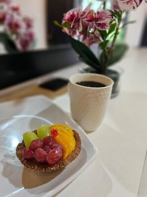A dessert on a white plate with a cup of coffee beside it. - Hotel y restaurante pura vida (Antigua Guatemala)