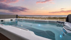 A hot tub with a view of the ocean at sunset. - Beachfront Retreat Sleeps 30 with Swim Spa, Fire Pit and Putt-Putt (Bolivar Peninsula)
