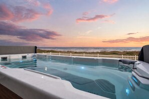 A hot tub with a view of the ocean at sunset. - Beachfront Retreat Sleeps 30 with Swim Spa, Fire Pit and Putt-Putt (Bolivar Peninsula)