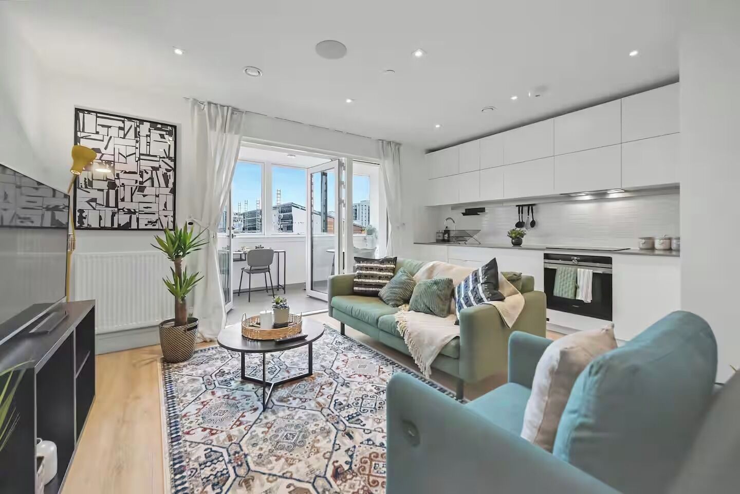 A modern living room with a sofa, coffee table, and a view of the city.