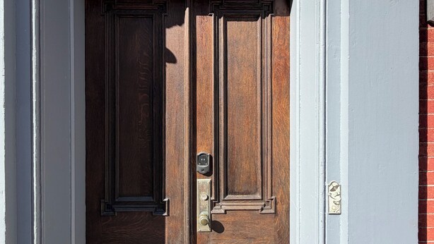 A wooden double door with a brass handle and a small window above it. - Downtown Jim Thorpe Stay at Charles Albright (Jim Thorpe)