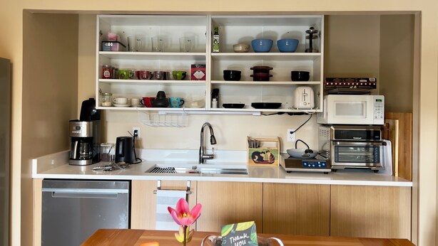 A kitchen with a dishwasher, coffee maker, microwave, toaster, and a sink. - Sweet One Bedroom (Victoria)