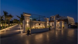 A modern building with a sign reading 'AGRAWAL' at the entrance, a gated driveway, and a well-lit pathway. - Shree Agrawal Avenue (Ujjain)