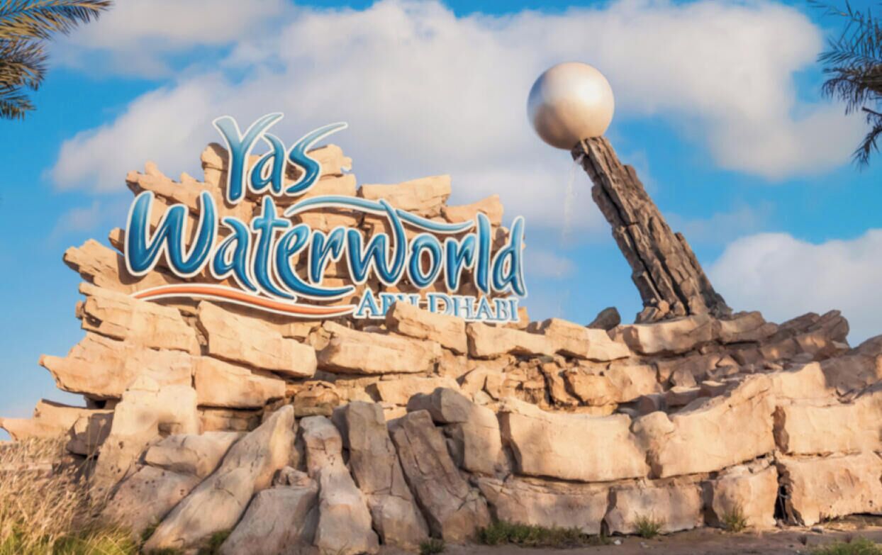 A rock formation with the text 'Yas Waterworld Abu Dhabi' and a spherical object on top.