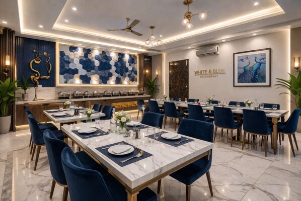 A restaurant with marble-topped tables, blue chairs, and a modern interior design. - WHITE & BLUE (New Delhi)