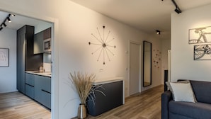 A modern living space with a kitchen, a dining area, and a seating area. - Family and Friends by Interhome (Riva del Garda)