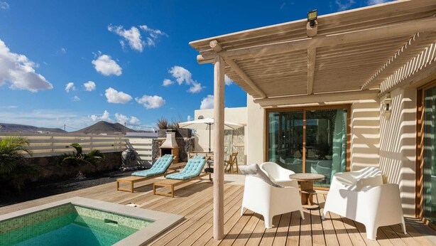 A poolside area with lounge chairs, a small pool, and a pergola. - INLAJARES VILLA - 15M POOL IN PARADISE (Lajares)