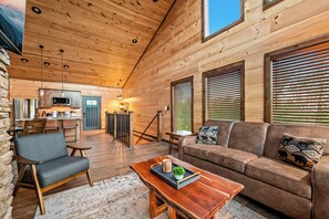 Ein Holzhaus-Interieur mit Küche, Essbereich und Wohnzimmer.