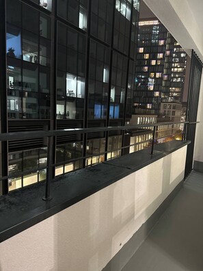 A modern building with reflective glass windows and a balcony with a metal railing. - Heart of Warsaw Hideaway (Warsaw)