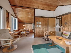 A cozy room with a wooden ceiling, a dining area with a table and chairs, and a sofa. - "Flory" - 400m from the sea by Interhome (Hvide Sande)