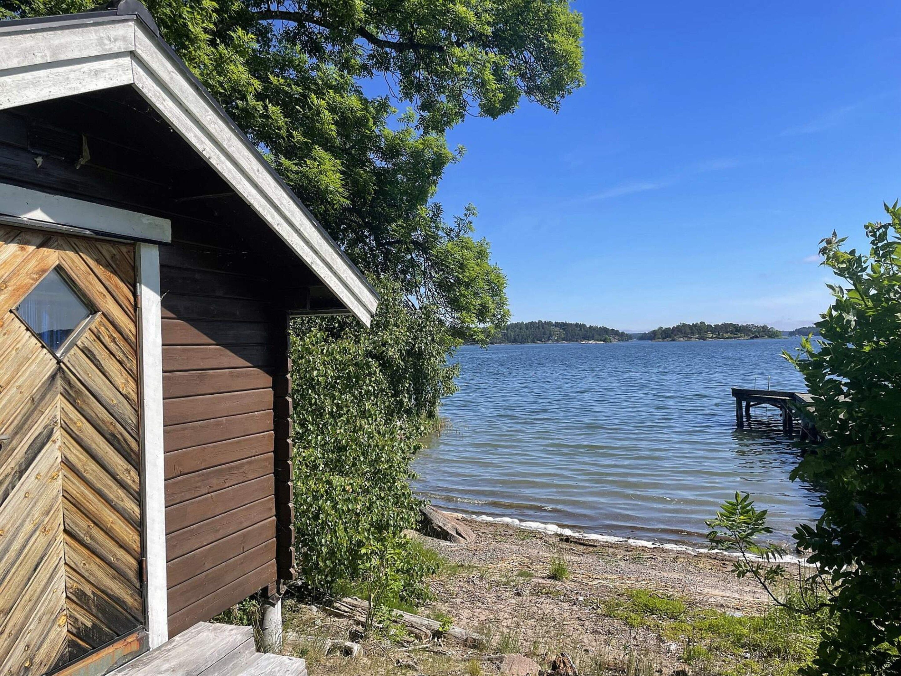 A cabin with a wooden exterior and a window with a diamond pattern.