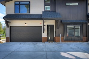 A modern two-story house with a garage, a front door, and a small porch area. - Moose Hollow 3 Bedroom Home (Winter Park)