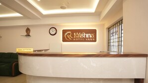 A reception desk with a sign reading 'Krishna Royal Club,' a clock, and a reception sign. - Krishna Royal Club (Guruvayur)