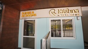 A building with a sign for 'Krishna Royal Club' and 'Suites & Accommodations.' - Krishna Royal Club (Guruvayur)