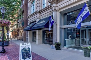 A building with 'The Liberty' signage, a brick facade, and a modern glass entrance.