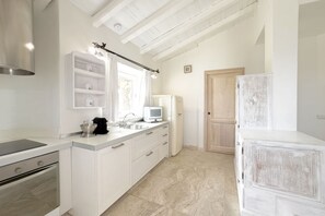 A modern kitchen with white cabinetry, a built-in oven, a microwave, and a sink. - <i>Suspended between Gallura granite and the blue of the sea, just minutes from Porto Cervo, where luxury is enjoyed in private.</i>In the prestigious setting of the <b>Costa Smeralda</b>, in <b>Abbiadori</b> and just <b>4 km from Porto Cervo</b>, Villa  (Abbiadori)