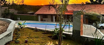 Cozy country house surrounded by nature, with a beautiful sunset view.