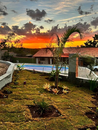 Cozy country house surrounded by nature, with a beautiful sunset view.