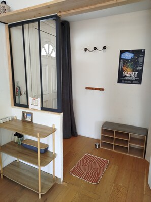 A room with a wooden desk, a mirror, a poster on the wall, a small shelf, and a patterned rug. - Quiet, single-storey family villa between sea, lake and mountains. (Servian)