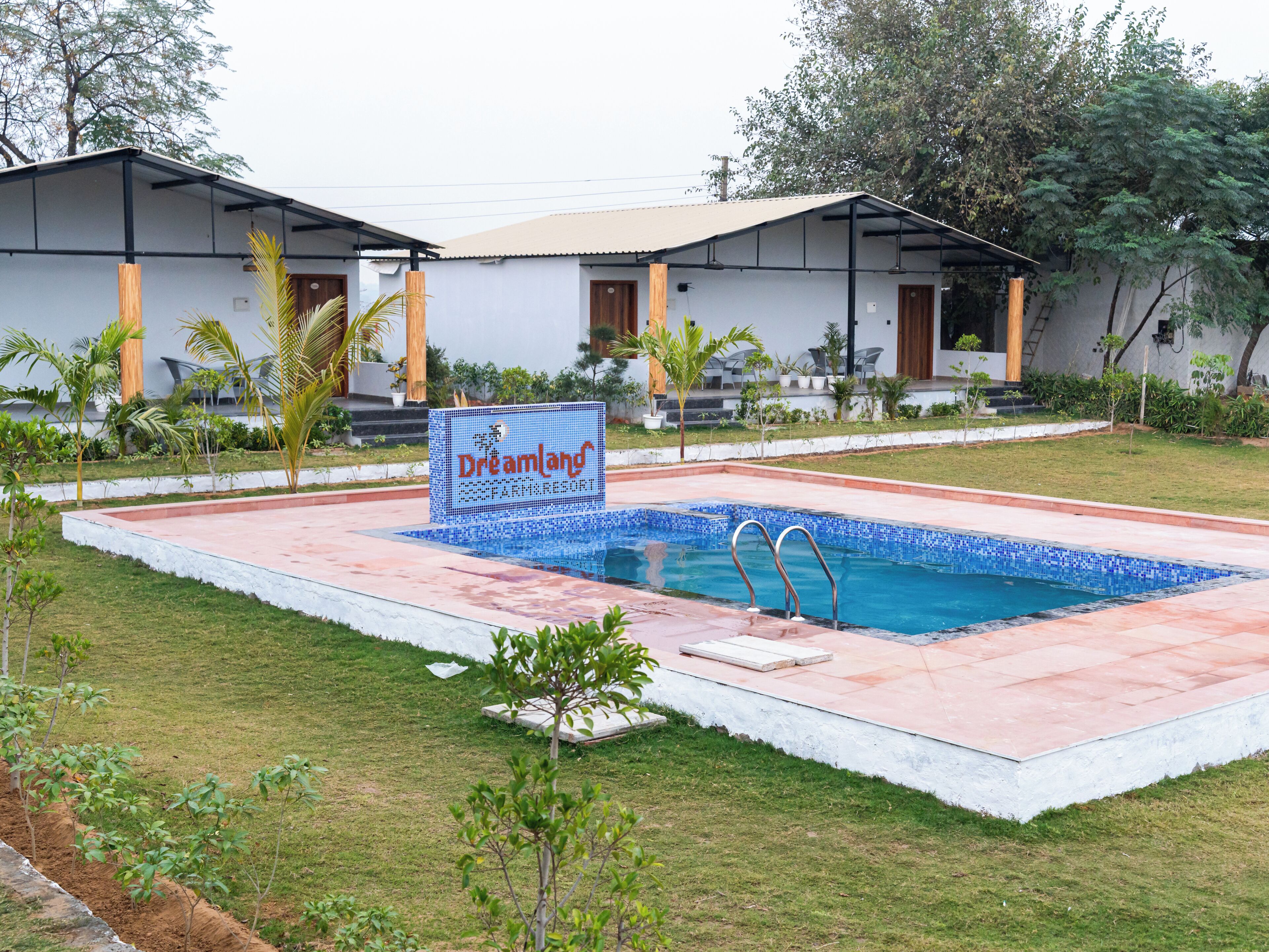 A pool area with a sign reading 'Dreamland Resort & Spa.'