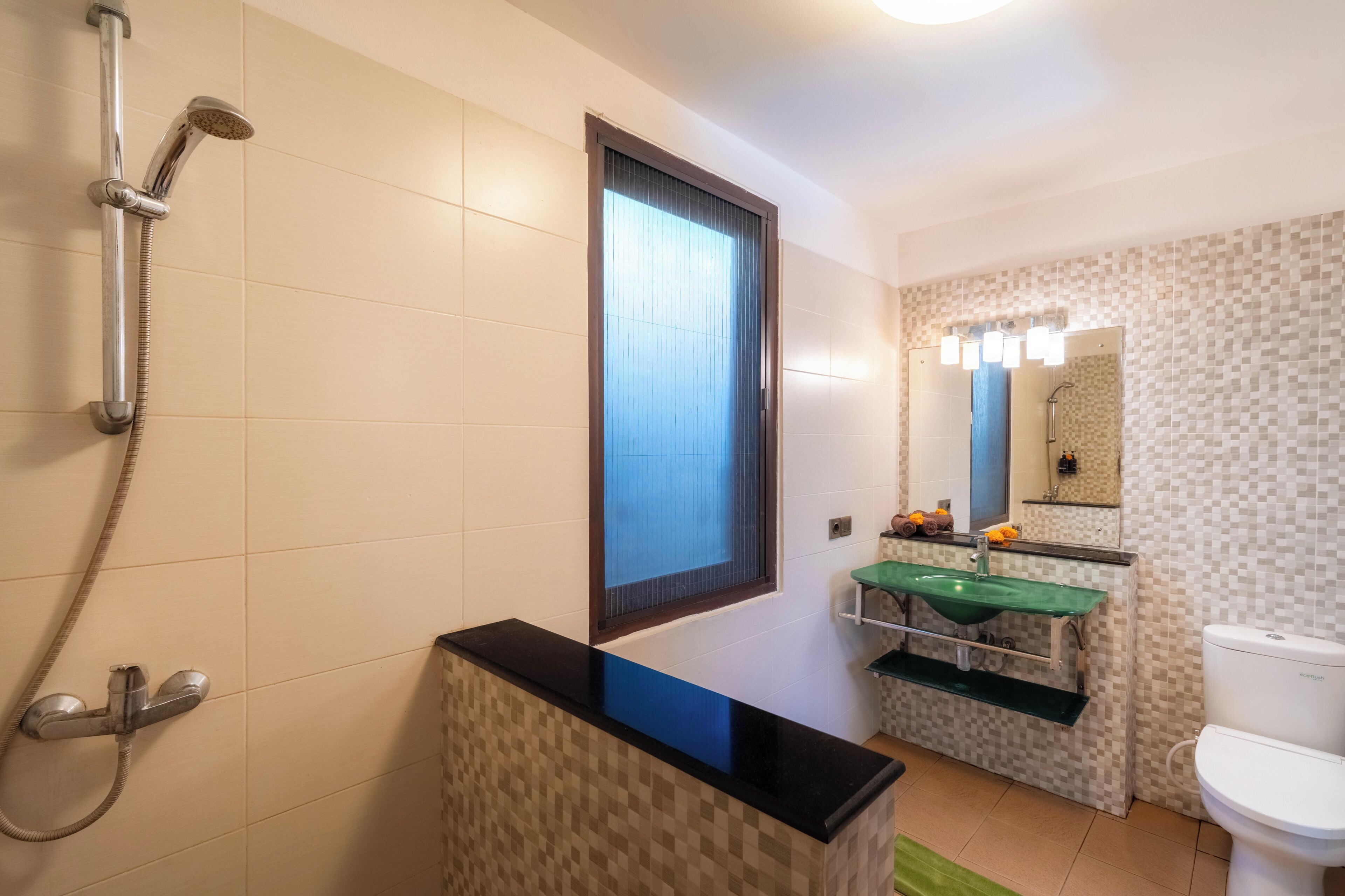 A bathroom with a shower, toilet, and sink.
