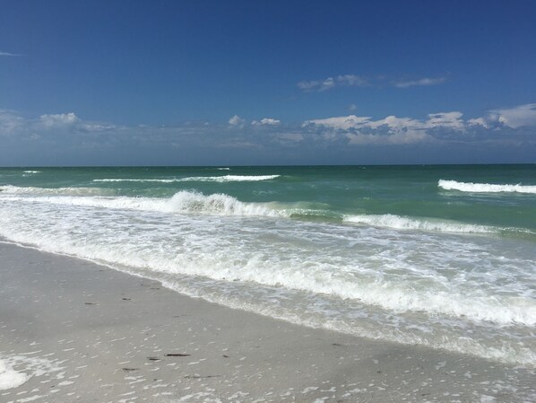 A beach with waves, clear sky, and distant horizon. - Dolphin Watch Waterfront | Indian Shores | Heated Pool | 3-Min Walk to Beach (Indian Shores)