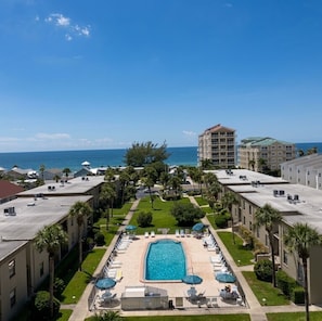 A hotel with a swimming pool, lounge chairs, and a view of the ocean. - Dolphin Watch Waterfront | Indian Shores | Heated Pool | 3-Min Walk to Beach (Indian Shores)
