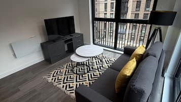 Superior Apartment, Balcony, City View | Living area | 55-inch Smart TV with digital channels