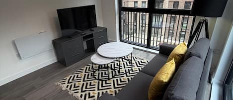 Superior Apartment, Balcony, City View | Living area | 55-inch Smart TV with digital channels