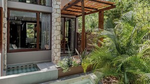 A modern house with a swimming pool, stone walls, and a pergola. - Siwa Tulum 2BR Luxury Condo with Private Pool + Rooftop (Tulum)