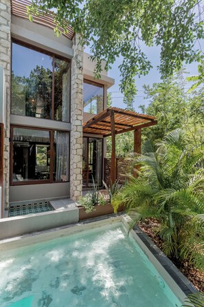 A modern house with a swimming pool, stone walls, and a pergola. - Siwa Tulum 2BR Luxury Condo with Private Pool + Rooftop (Tulum)