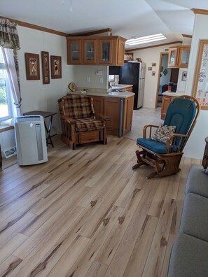 A compact living space with a kitchen, dining area, and seating. - CAMP : 2-bedroom mobile home camp - lake access to Chazy Lake in Ellenburg Depot (Ellenburg Depot)