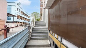 A set of outdoor stairs leading to a building entrance, surrounded by modern architecture. - Townhouse Vellore Fort (Vellore)