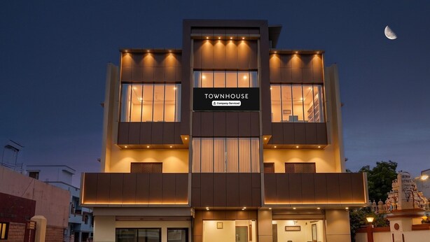 A multi-story building with a sign reading 'TOWNHOUSE & Company-Serviced.' - Townhouse Vellore Fort (Vellore)