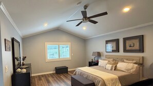 A bedroom with a bed, a ceiling fan, a window, a nightstand, and a dresser. - Clean, Bright & Comfortable Pool Home w/separate Poolhouse Studio (Los Angeles)