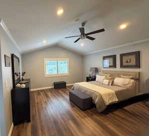 A bedroom with a bed, a ceiling fan, a window, a nightstand, and a dresser. - Clean, Bright & Comfortable Pool Home w/separate Poolhouse Studio (Los Angeles)