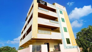 A multi-story hotel with a signboard, balconies, and a gated entrance. - Classic Chhathrapathi Residency (Tirupati)
