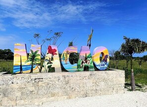 A sign with painted letters spelling 'LAGOON' against a clear sky. - Ruka Hotel  (Punta Cana)