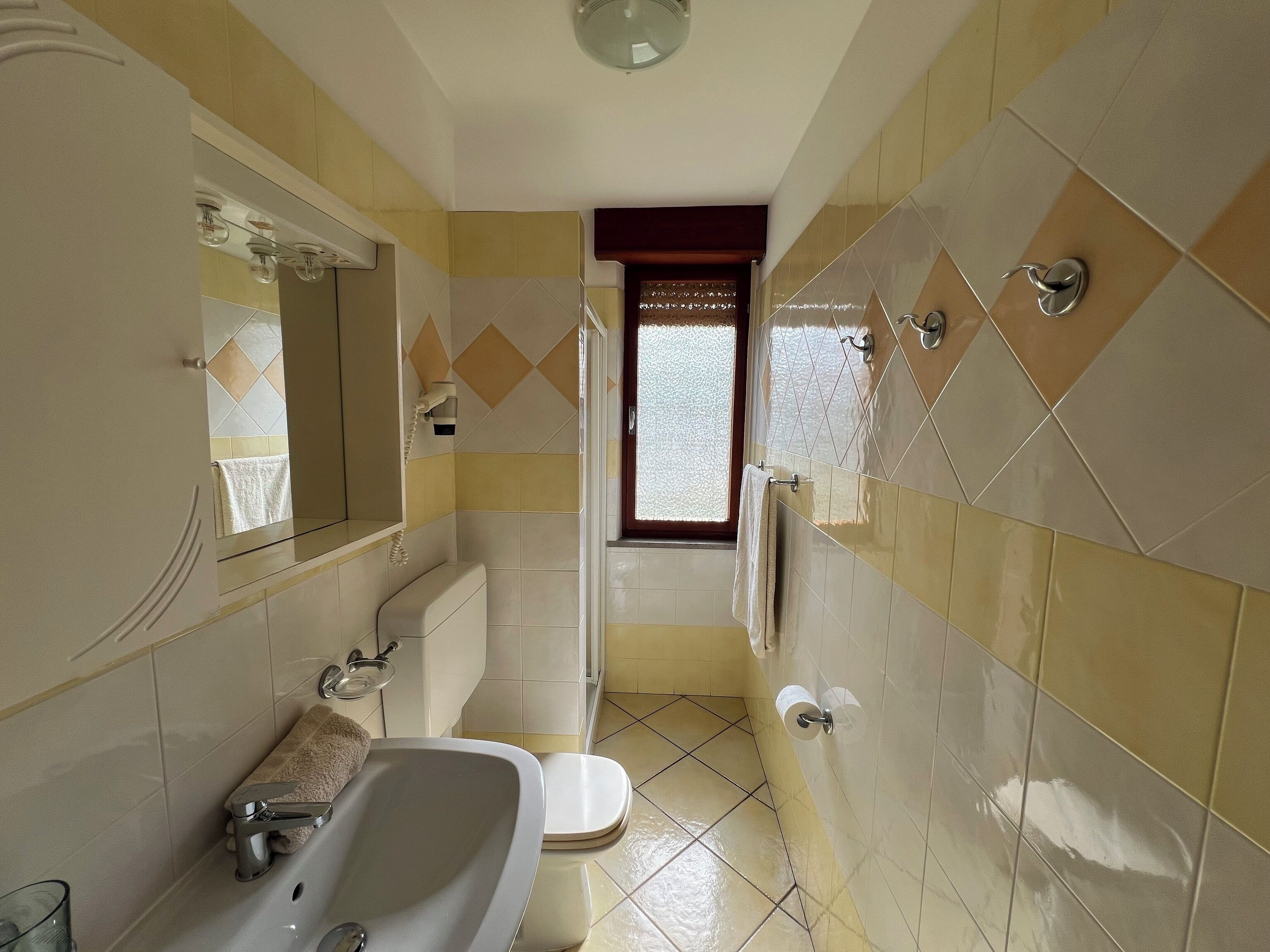 A bathroom with a bathtub, toilet, and sink.