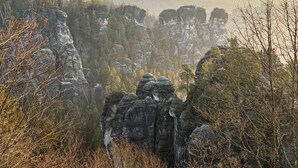 Un paysage montagneux caractérisé par des formations rocheuses et des arbres.