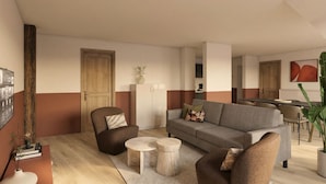 Un salon moderne avec un canapé, des fauteuils, une table basse et, au fond, un coin repas.