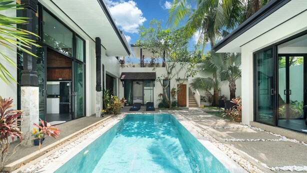 A modern house with a swimming pool, large windows, and a garden. - Wings 25 Laguna (Phuket)