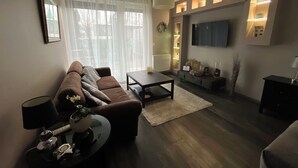 A modern living room with a sofa, coffee table, and TV.