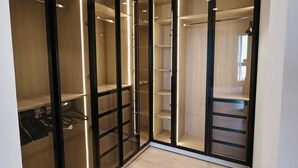 Un dressing avec de nombreuses étagères et un espace pour suspendre les vêtements.