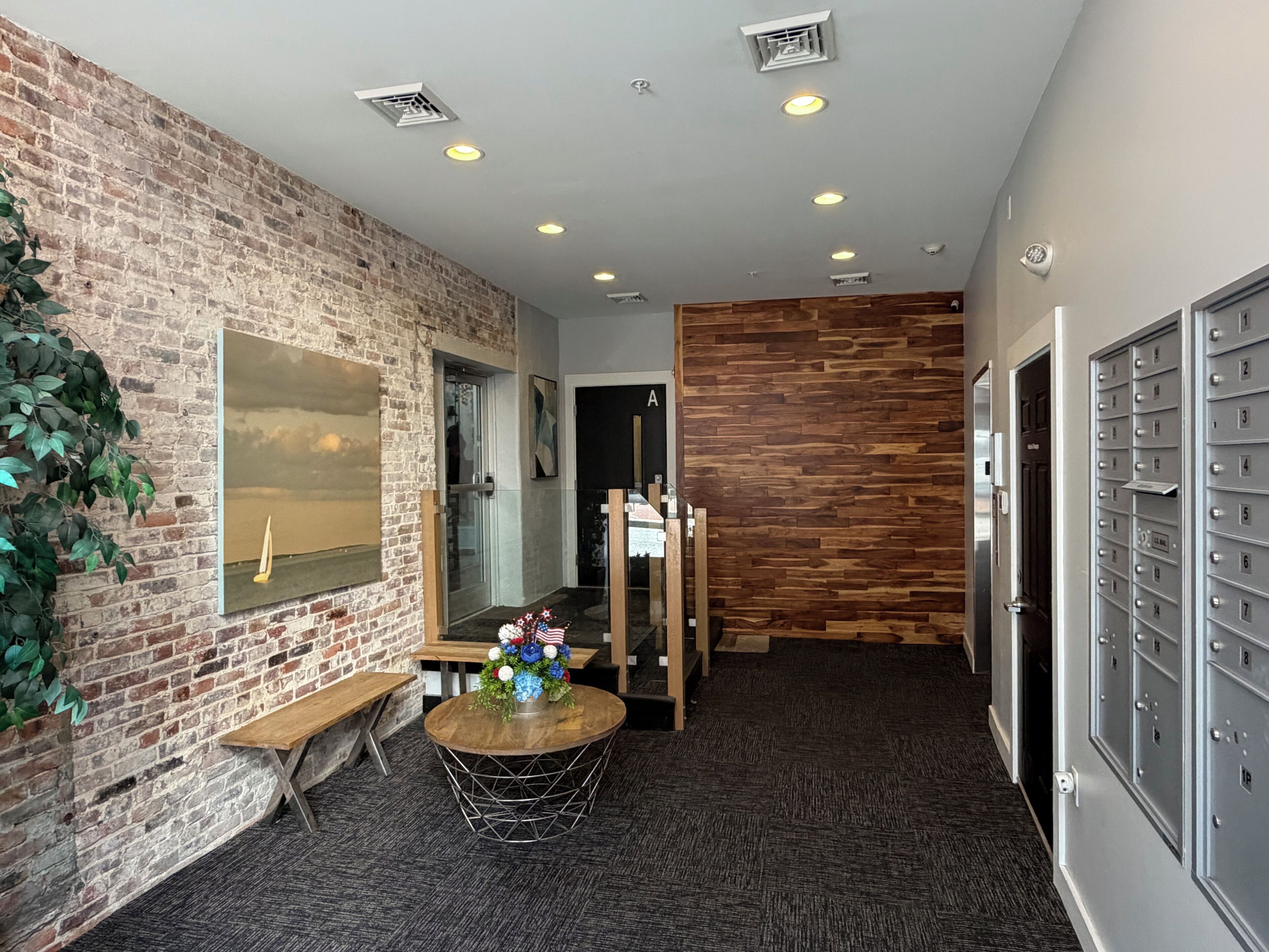 Lobby area with trash room and elevator. 