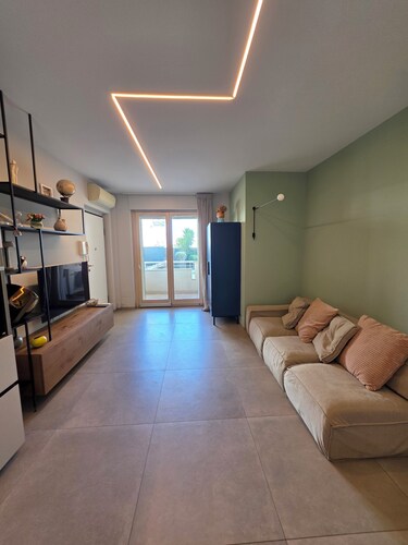 Elegantly renovated beachfront apartment with a courtyard and parking space