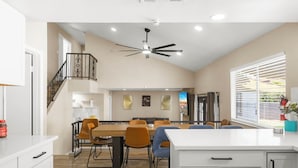 A spacious kitchen with a dining area, a staircase, and a ceiling fan. - Pool • Hot tub • Arcades • Air Hockey • Foosball • Mini-Golf • 20 Guests (Las Vegas)