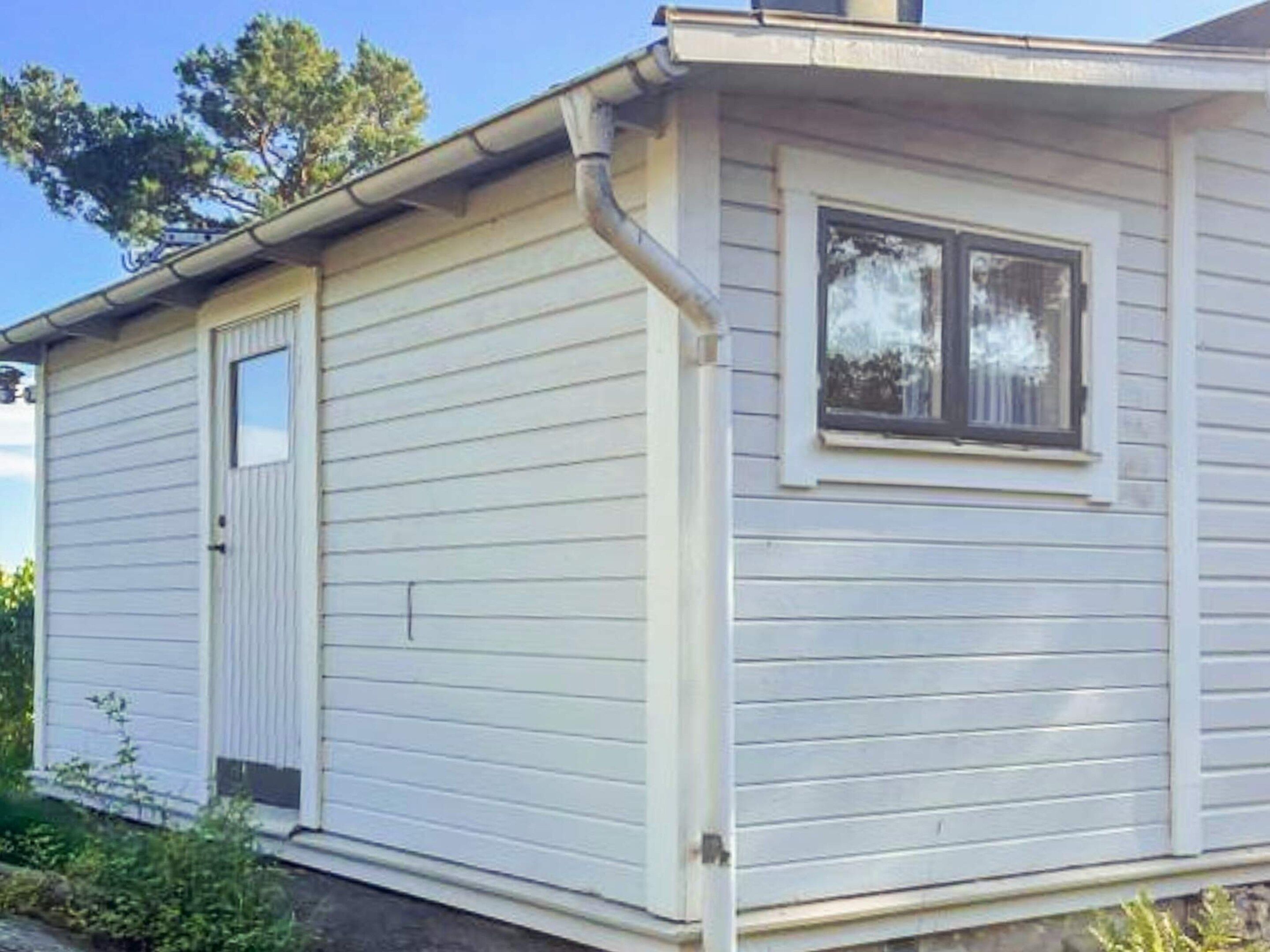 A single-story house with a front door and a window.